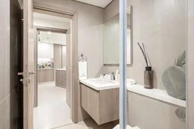 a bathroom with a sink and a mirror at FIRST CLASS 2BR Marina, Sea & Ain Views in Dubai