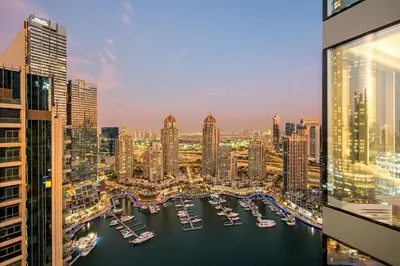 a view of a city with boats in a harbor at FIRST CLASS 2BR Marina, Sea & Ain Views in Dubai