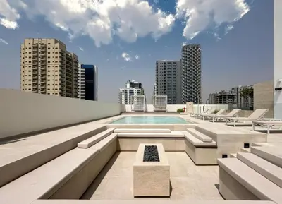 a swimming pool on the roof of a building at Modern Studio Apartment in Binghatti Tulip with Pool, Parking, Gym in Dubai