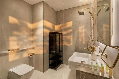 a bathroom with a sink and a toilet and a shower at Modern Studio Apartment in Binghatti Tulip with Pool, Parking, Gym in Dubai