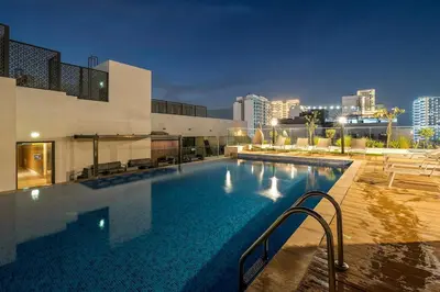 a large swimming pool in front of a building at FIRST CLASS Studio Charming Cozy Comfort in Dubai