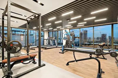 an apartment gym with a view of the city at FIRST CLASS Studio Charming Cozy Comfort in Dubai
