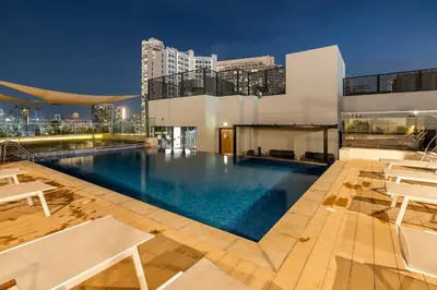 a large swimming pool on top of a building at FIRST CLASS Studio Charming Cozy Comfort in Dubai