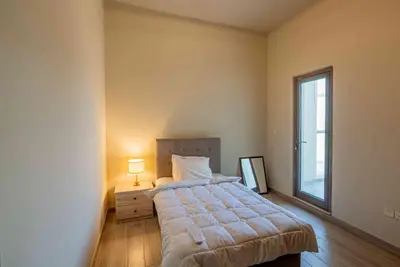 a bedroom with a large bed and a window at Executive 4BR Townhouse - Al Furjan in Dubai