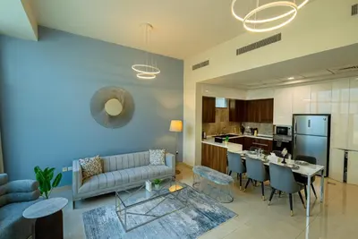 a living room with a couch and a table at Executive 4BR Townhouse - Al Furjan in Dubai