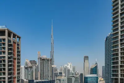 a view of a city skyline with a tall skyscraper at Elegant Studio with Iconic Burj Khalifa Views in Dubai