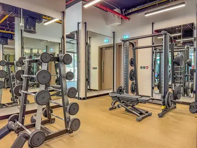 a gym with several rows of squat racks at Elegant Studio with Iconic Burj Khalifa Views in Dubai