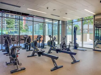 a gym with a bunch of treadmills and machines at Elegant Studio with Iconic Burj Khalifa Views in Dubai