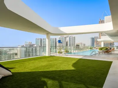 a view from the roof of a building with a lawn at Dubai Miracle Garden Modern Luxury Studio Pool, Padel Court & Sauna Arjan in Dubai