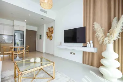 a living room with a tv and a vase at very nice apartment in Burj khalifa area downtown in Dubai