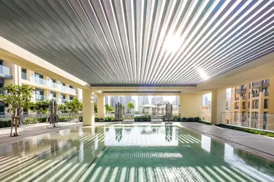 a large swimming pool in a building with a ceiling at very nice apartment in Burj khalifa area downtown in Dubai