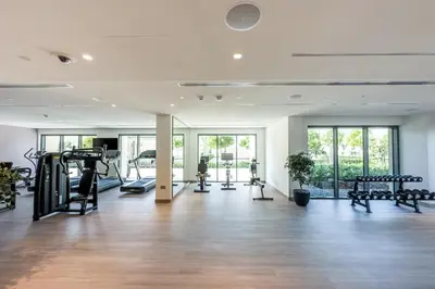 a gym with treadmills and machines in a room at very nice apartment in Burj khalifa area downtown in Dubai