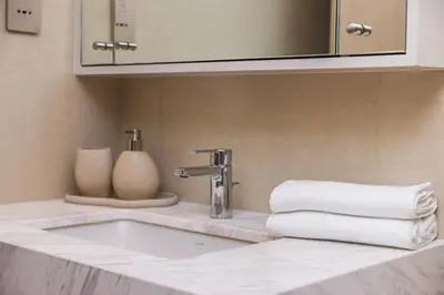 a bathroom with a sink and a mirror and towels at very nice apartment in Burj khalifa area downtown in Dubai