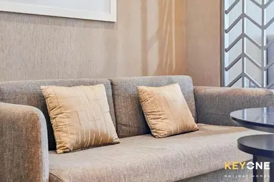 a couch with two pillows on it in a room at Sleek Studio in Privé with Stunning Canal View in Dubai