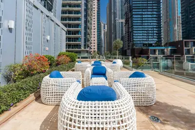 a row of chairs on the roof of a building at Marina | Canal View Studio in Cayan Tower in Dubai