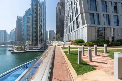 a city skyline with tall buildings and a body of water at Marina | Canal View Studio in Cayan Tower in Dubai