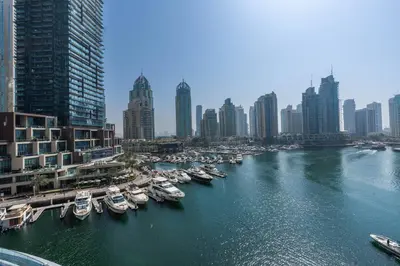 a group of boats docked in a river in a city at Marina | Canal View Studio in Cayan Tower in Dubai