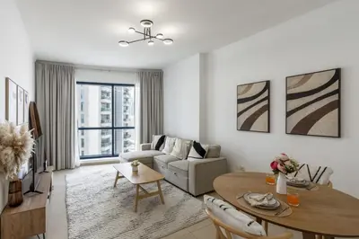 a living room with a table and a couch at Modern Comfort - Convenient - Prime JLT Living in Dubai