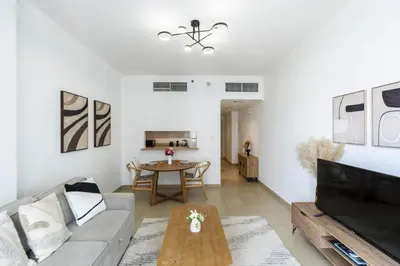 a living room with a couch and a table at Modern Comfort - Convenient - Prime JLT Living in Dubai