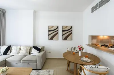 a living room with a couch and a table at Modern Comfort - Convenient - Prime JLT Living in Dubai