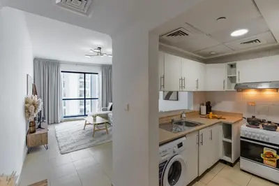 a kitchen with a sink and a stove at Modern Comfort - Convenient - Prime JLT Living in Dubai