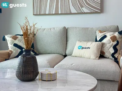 a living room with a couch and a glass table at HiGuests - Peninsula Luxury 1 BR with Stunning Water Views in Dubai