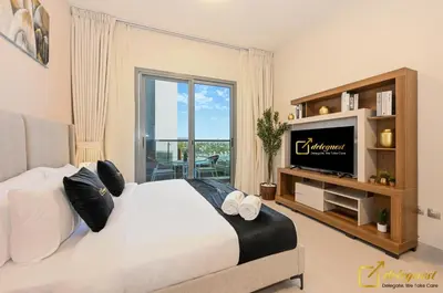 a bedroom with a large bed and a television at Luxury Studio in Dubai Hills by Deleguest in Dubai