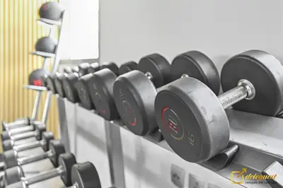 a row of dumbbells on a rack in a gym at Luxury Studio in Dubai Hills by Deleguest in Dubai