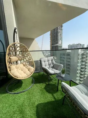 a balcony with two chairs and a couch on a roof at Luxury 1BR W Private Pool Binghatti Royale in Dubai