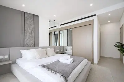 a bedroom with a large white bed with white pillows at Luxury 1BR W Private Pool Binghatti Royale in Dubai