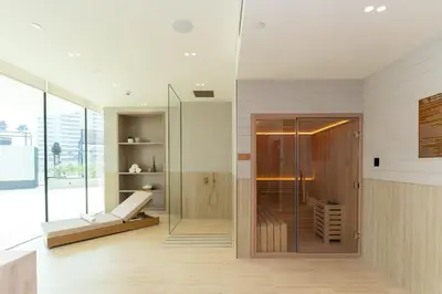 a bathroom with a shower and a glass door at Luxury 1BR W Private Pool Binghatti Royale in Dubai