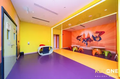 a room with colorful walls and a table and chairs at Elegant Studio Living in Privé in Dubai
