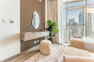 a bedroom with a bed and a large window at Elegant 3BR, Skyline Retreat in Downtown Dubai - Imperial Avenue, Downtown Dubai by Deluxe Holiday Homes in Dubai