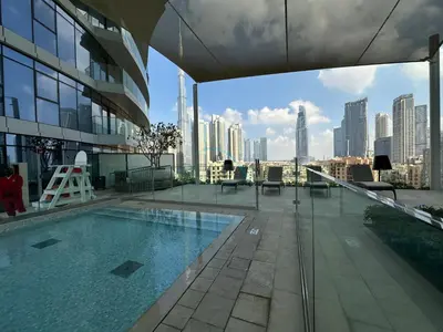 a large swimming pool on the roof of a building at Elegant 3BR, Skyline Retreat in Downtown Dubai - Imperial Avenue, Downtown Dubai by Deluxe Holiday Homes in Dubai