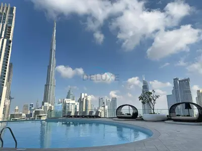 a swimming pool on the roof of a building with a city at Elegant 3BR, Skyline Retreat in Downtown Dubai - Imperial Avenue, Downtown Dubai by Deluxe Holiday Homes in Dubai