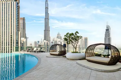a pool on the rooftop of a building with a view of the city at Seraya Residences at Imperial Avenue Dubai in Dubai