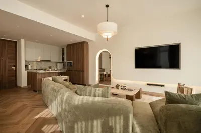 a living room with a couch and a table at Seraya Residences at Imperial Avenue Dubai in Dubai