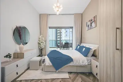 a bedroom with a large bed and a mirror at Spacious 1BR Elite Business Bay Residence in Dubai