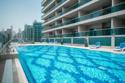 a large swimming pool on the roof of a building at Spacious 1BR Elite Business Bay Residence in Dubai