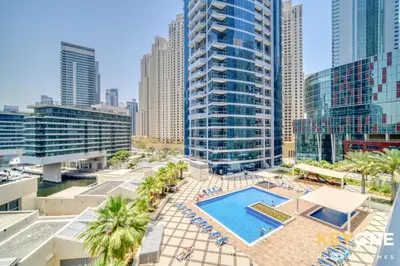 an overhead view of a pool in a city with tall buildings at Modern One Bedroom with Stylish Touches in Dubai