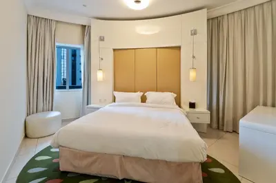 a bedroom with a large bed and a bathroom at Next to Dubai Mall & Burj Khalifa I Luxury Design in Dubai