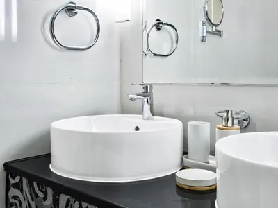 a white bathroom with a sink and two mirrors at Next to Dubai Mall & Burj Khalifa I Luxury Design in Dubai