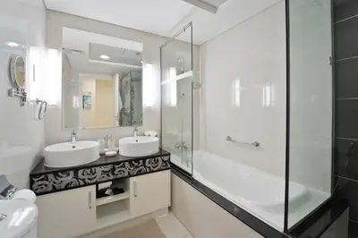 a bathroom with two sinks and a shower at Next to Dubai Mall & Burj Khalifa I Luxury Design in Dubai