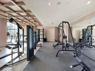 a gym with treadmills and cardio machines at Elevated 1BR with Private Pool at Binghatti Phantom in Dubai