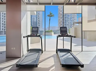 two exercise bikes in a building with a pool at Elevated 1BR with Private Pool at Binghatti Phantom in Dubai