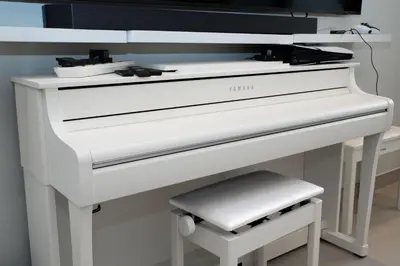 a white piano with a stool in front of it at Escape24 Luxury Studio 100