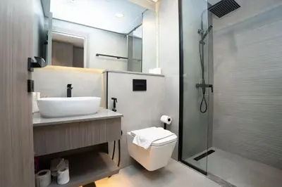 a bathroom with a toilet and a sink and a shower at Escape24 Luxury Studio 100
