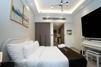 a bedroom with a white bed and a piano at Escape24 Luxury Studio 100
