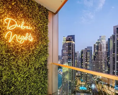 a room with a window with a view of a city at Stunning 2BR Burj Khalifa View from Infinity Pool Grande Signature Residences in Dubai