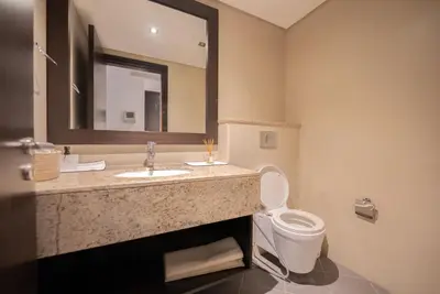 a bathroom with a sink and a toilet and a mirror at One bedroom appartment Palm Jumeirah in Dubai